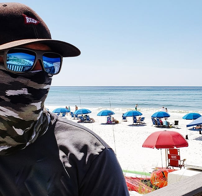 Man wearing a bandana face cloth at the beach in california during Covid-19